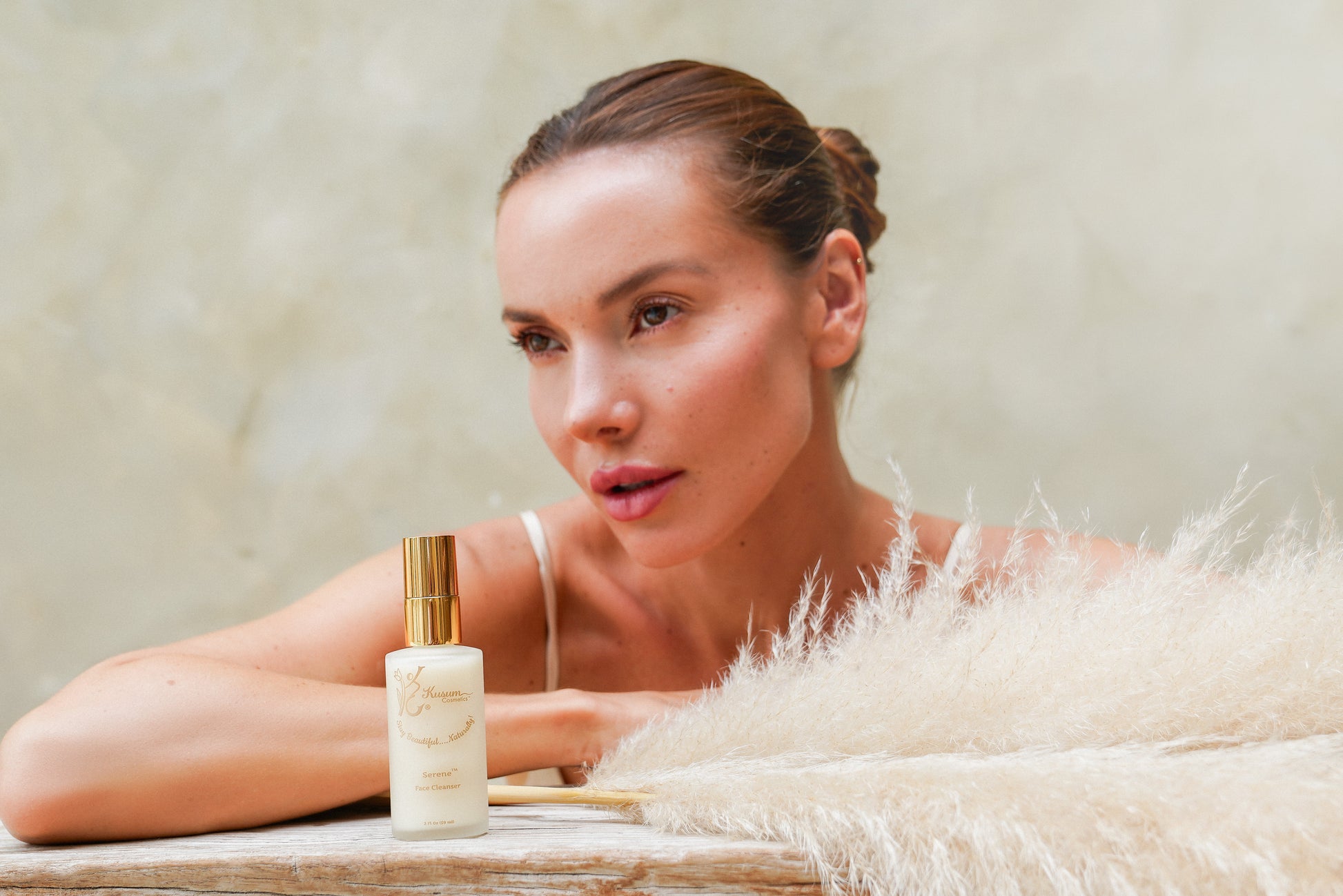 person with luxury natural skincare face cleanser
