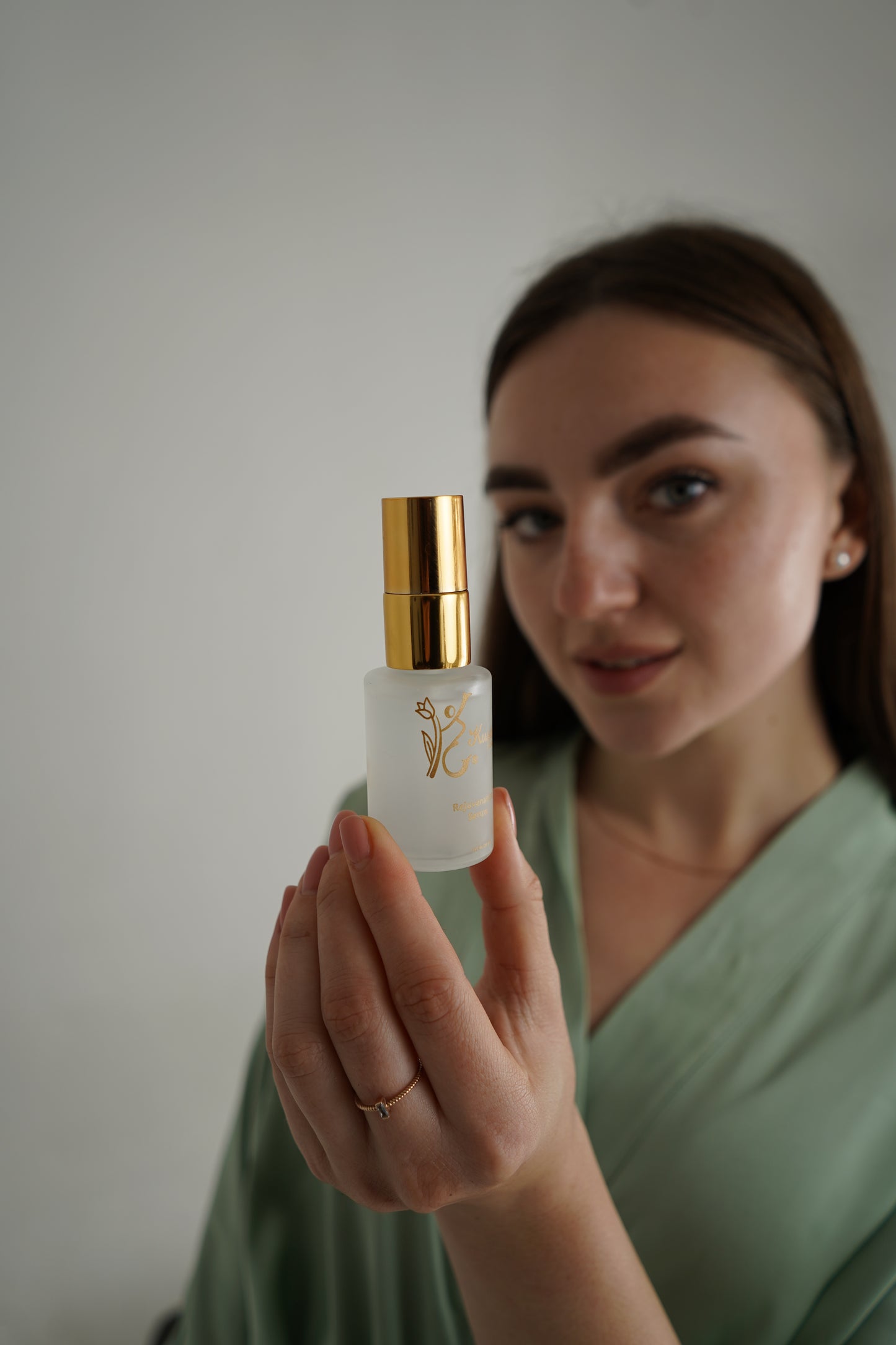 real life person holding luxury natural skincare face serum