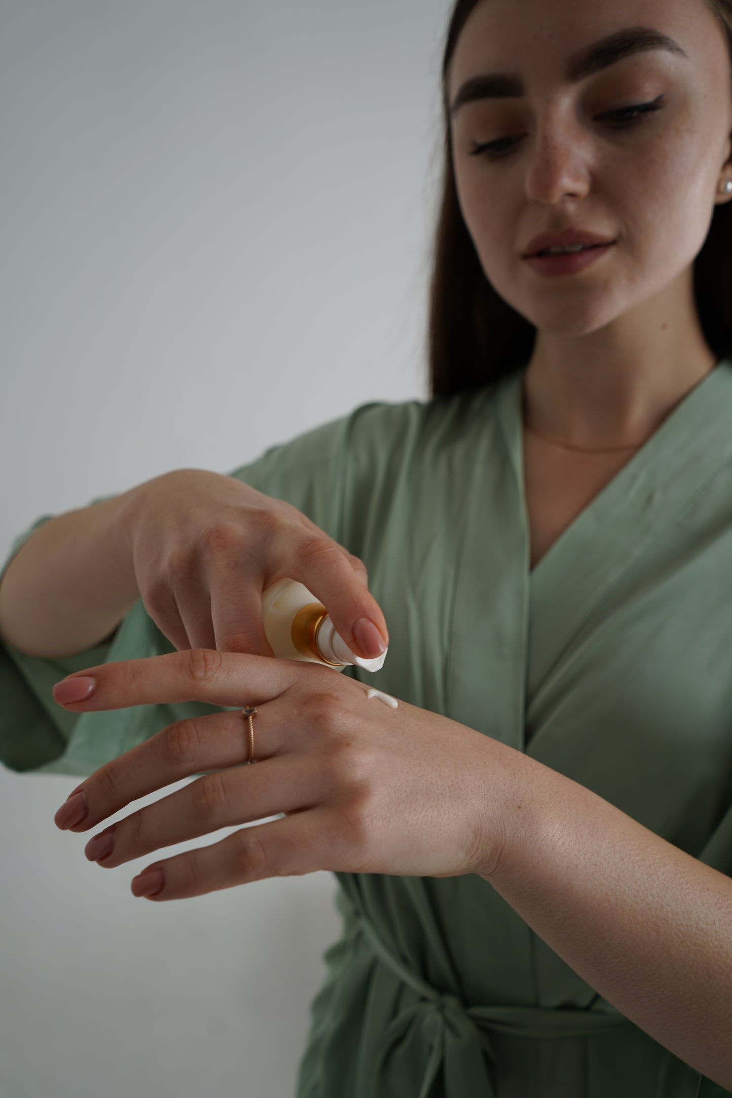 person using luxury natural skincare body lotion