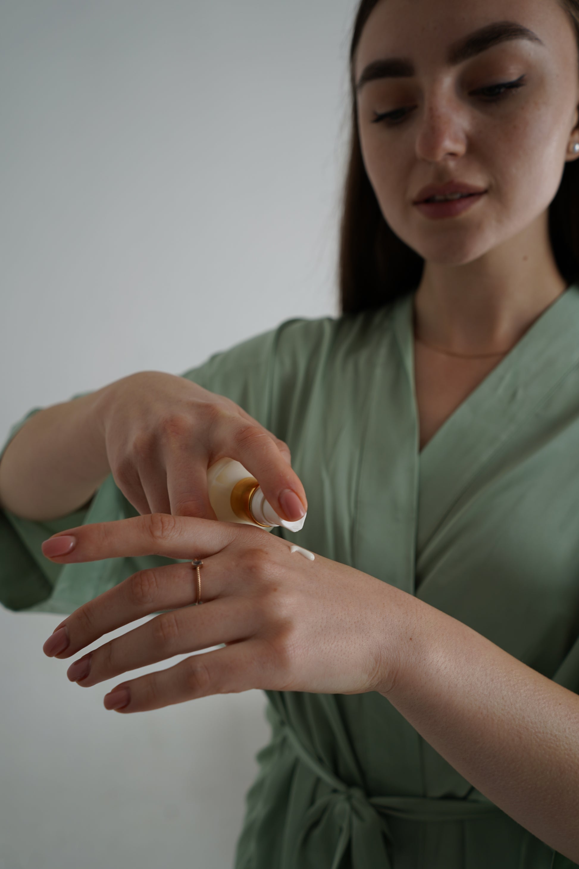 person using luxury natural skincare body lotion
