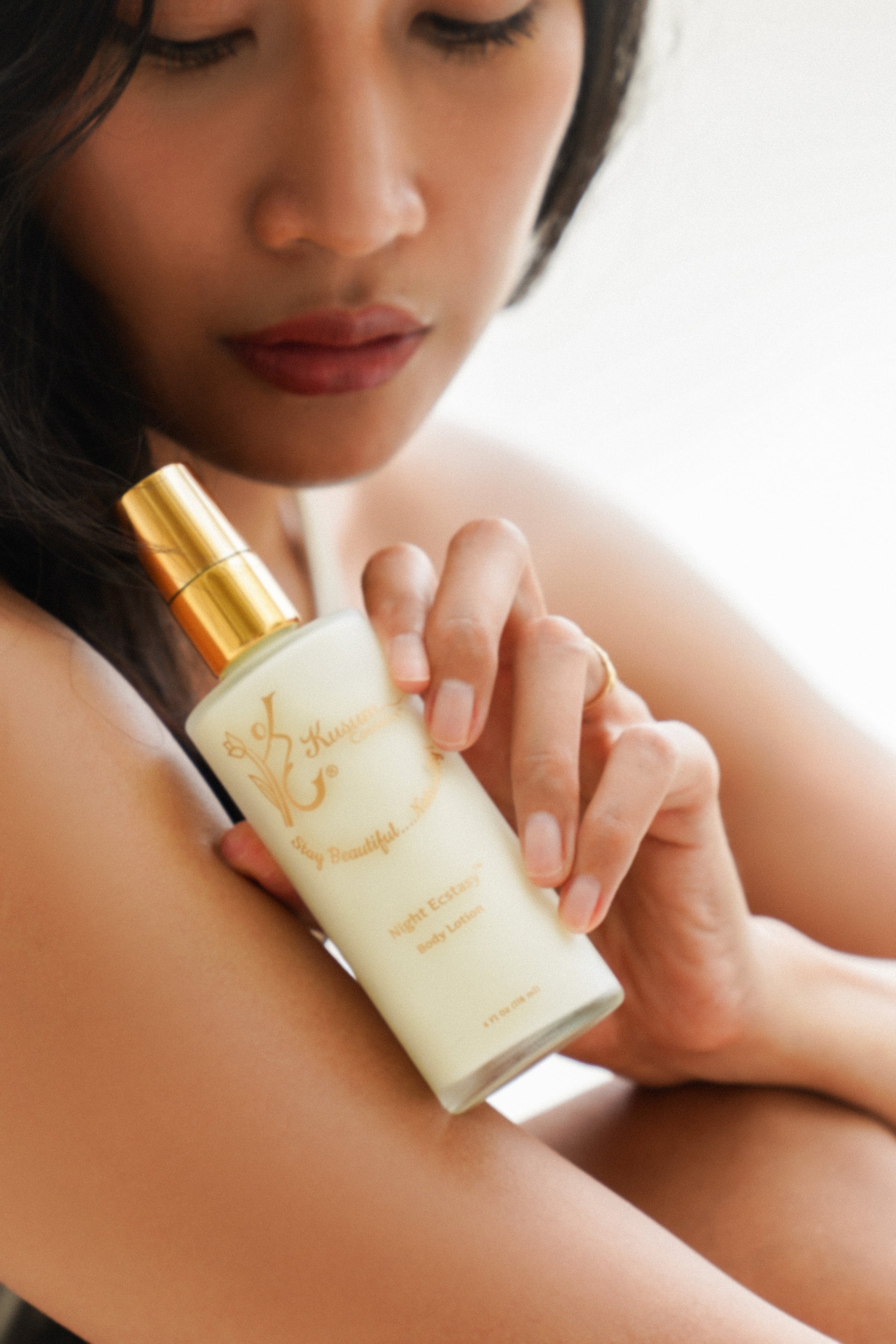 person holding luxury natural skincare body lotion