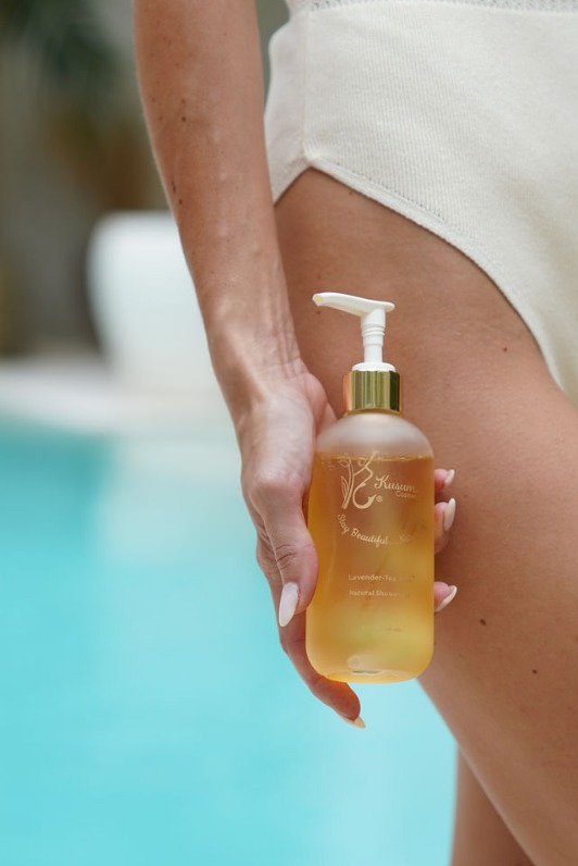 front shot person holding luxury natural skincare peppermint lemon natural shower gel