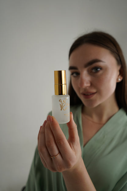 real life person holding luxury natural skincare face serum